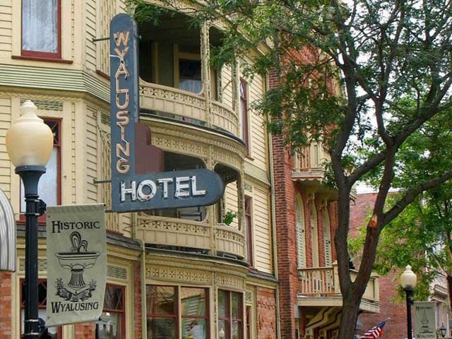 Facade of the historic Wyalusing Hotel, a brick and yellow-clapboard old fashioned street hotel